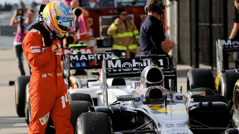 Fernando Alonso inspects the McLaren