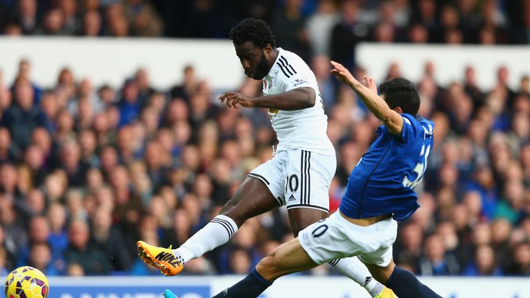 Wilfried Bony of Swansea City is challenged by Gareth Barry of Everton during the Barclays Premier League match 