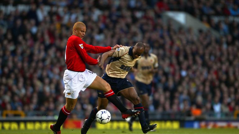 MANCHESTER - MAY 8:  Sylvain Wiltord of Arsenal takes the ball past Wes Brown of Manchester United during the FA Barclaycard Premiership match played at Ol