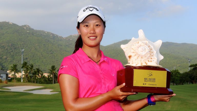 Xi Yu Lin holds the trophy