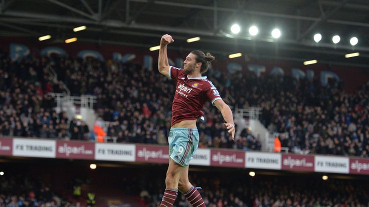 West Ham United's English striker Andy Carroll leaps in the air as he celebrates scoring West Ham's second goal against Swansea City.