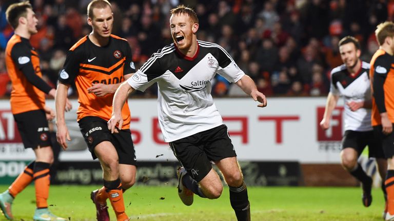 A happy Adam Rooney turns after netting Aberdeen's second of the afternoon at Tannadice