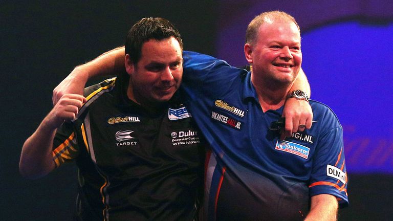 Adrian Lewis is congratulated by Raymond van Barneveld after hitting his nine-darter