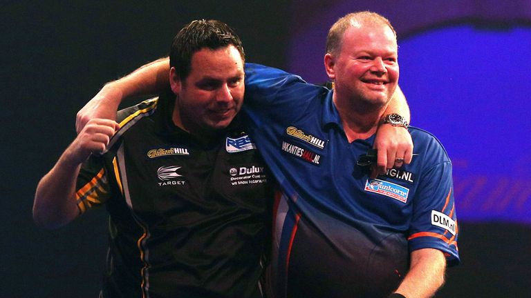 LONDON, ENGLAND - DECEMBER 30: Adrian Lewis of England is congratulated by Raymond van Barneveld of Holland after hitting a nine darter during their third 
