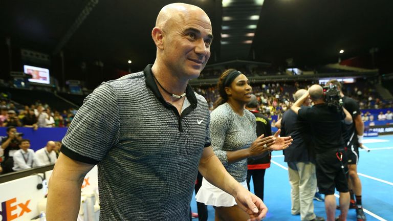 Andre Agassi of the Singapore Slammers walk onto the court after their teams victory against the Indian Aces