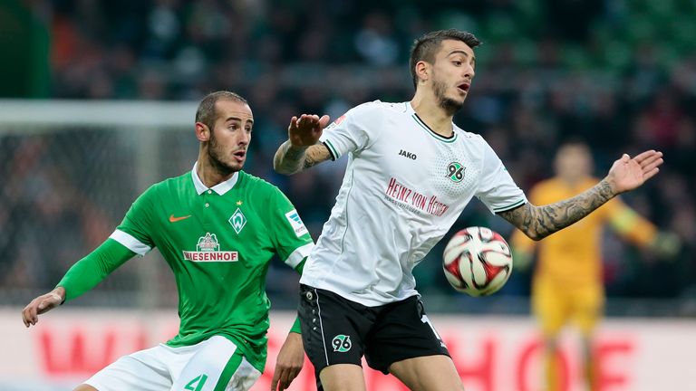 Alejandro Galvez (L) of Bremen and Joselu Mato (R) of Hannover compete for the ball