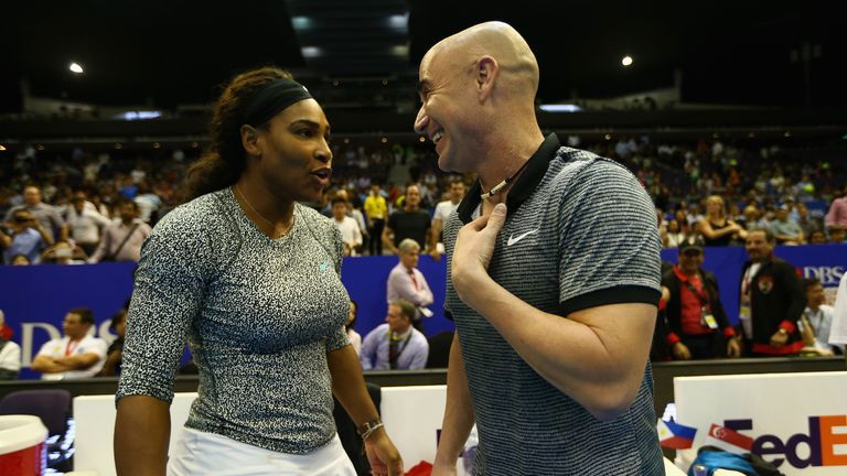 SINGAPORE - DECEMBER 03:  Serena Williams and Andre Agassi of the Singapore Slammers talk after their teams victory against the Indian Aces during the Coca