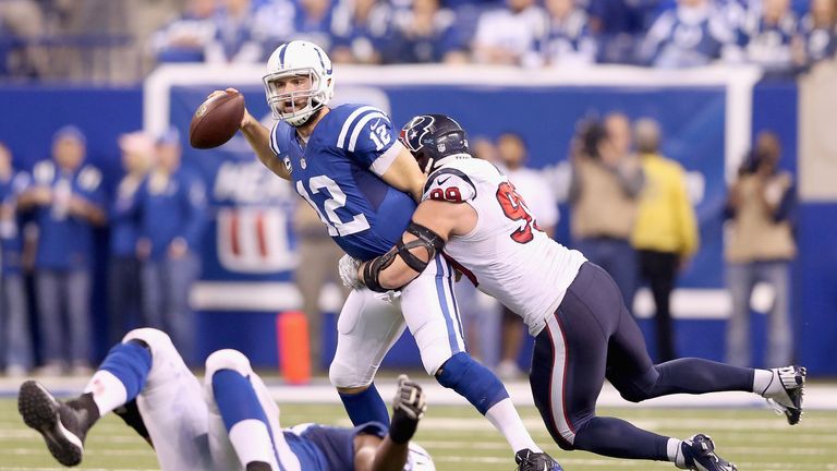 INDIANAPOLIS, IN - DECEMBER 14:  Andrew Luck #12 of the Indianapolis Colts is sacked by J.J. Watt #99 of the Houston Texans during the game at Lucas Oil St