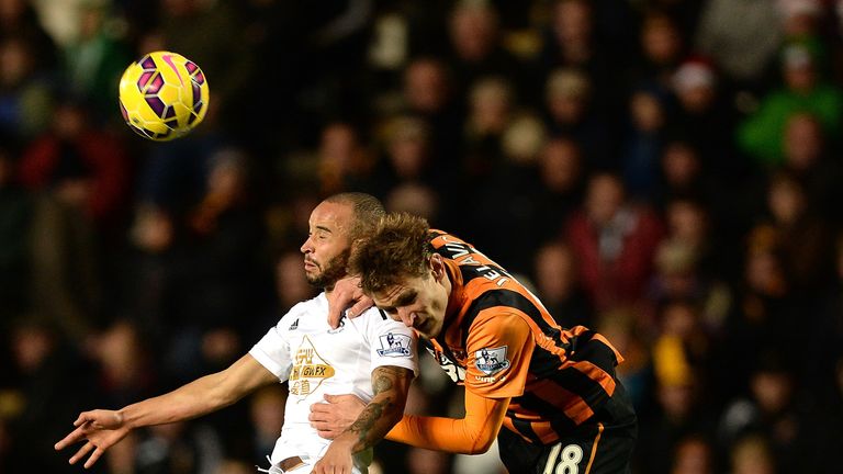 Ashley Richards of Swansea City goes up for a header with Nikica Jelavic of Hull City during the Barclays Premier League match