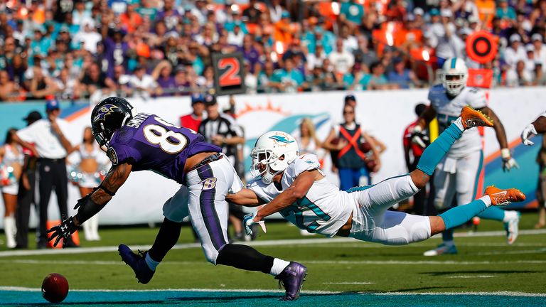 Brent Grimes' last-ditch dive stops Ravens' Steve Smith from scoring a touchdown. 