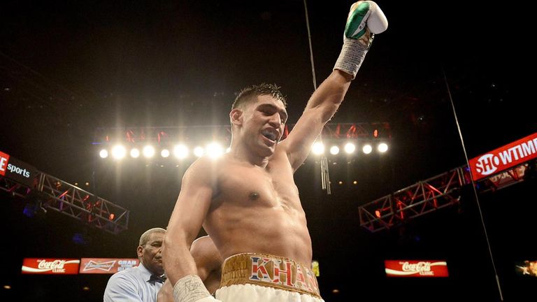 Amir Khan (L) celebrates at the end of the 12th round against Devon Alexander during their welterweight bout at the MGM Grand