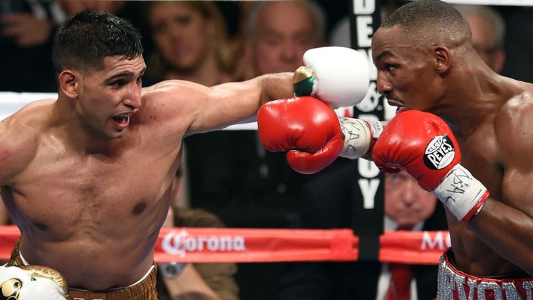 Amir Khan (L) throws a left at Devon Alexander in the eighth round of their welterweight bout at the MGM Grand Garden Arena