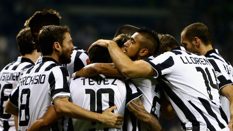 Carlos Tevez of Juventus celebrates with teammates after scoring his team's first goal