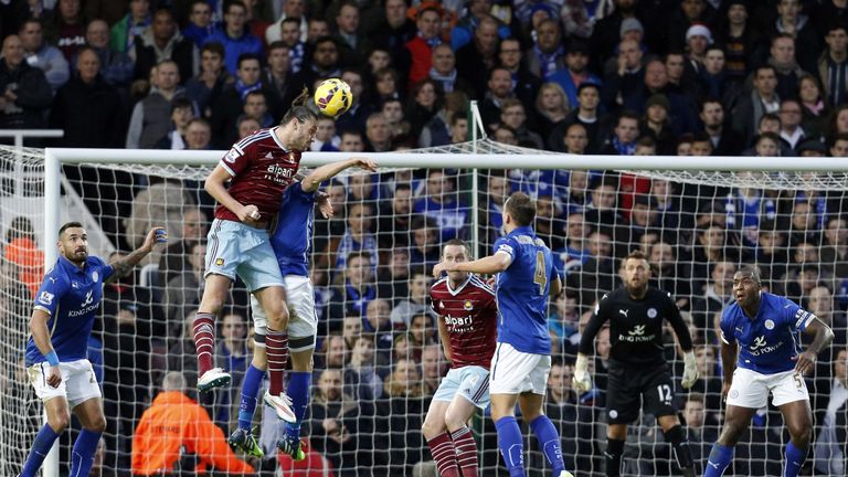 West Ham United's English striker Andy Carroll (2nd L) climbs to win a header during the football match between West Ham United and Leicester 