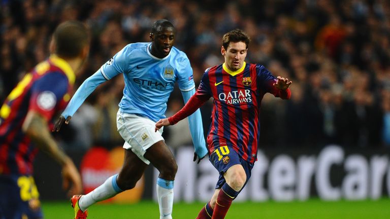Lionel Messi of Barcelona competes with Yaya Toure of Manchester City during the UEFA Champions League Round of 16 first leg at the Etihad Stadium, 2014