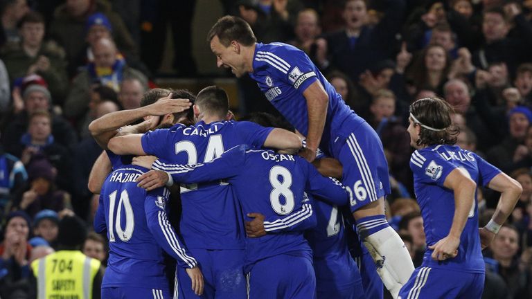 Chelsea's English defender John Terry (R) leaps onto the mob of Chelsea players congratulating Chelsea's Brazilian-born Spanish striker Diego Costa