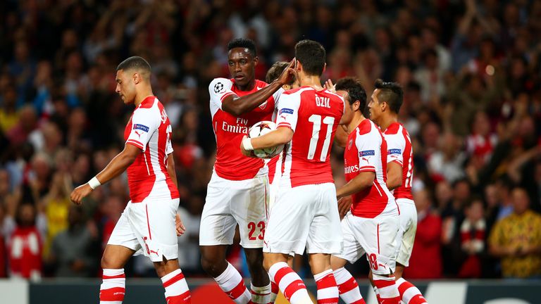 LONDON, ENGLAND - OCTOBER 01:  Danny Welbeck of Arsenal celebrates with team-mates after scoring the opening goal during the UEFA Champions League group D 