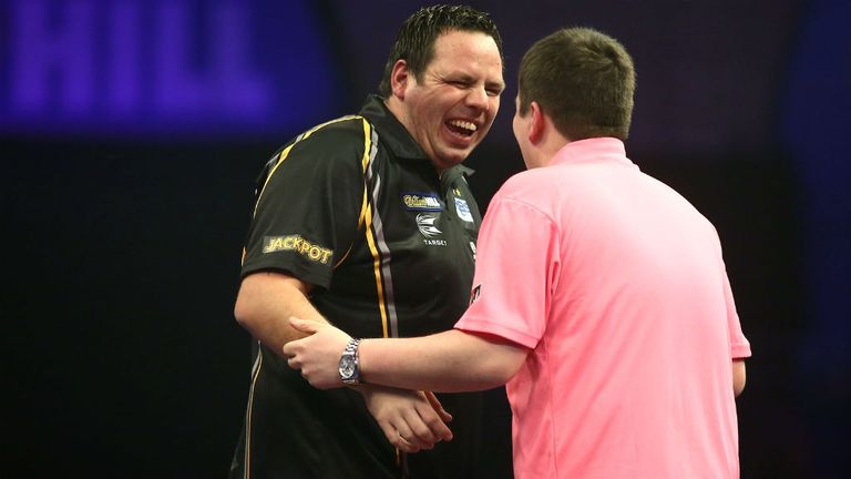 Adrian Lewis celebrates with Keegan Brown after he wins their second round match at Alexandra Palace