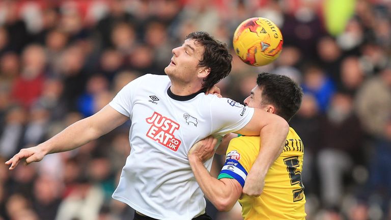 Derby County's Chris Martin (left) and Norwich City's Russell Martin (right) battle for the ball in the air during the Sky Bet Championship match