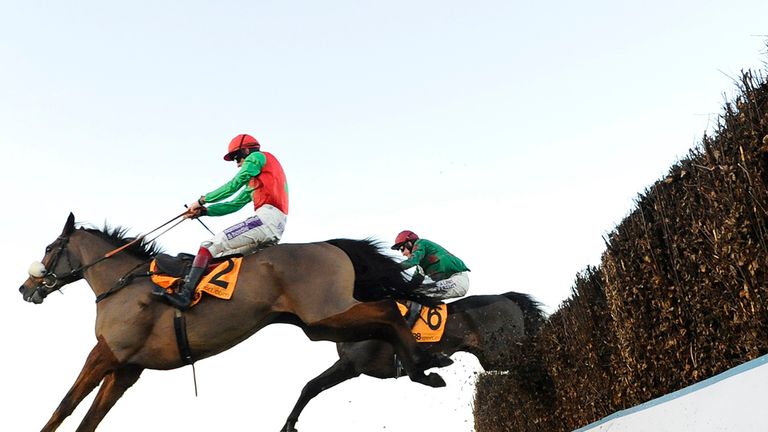 ESHER, ENGLAND - DECEMBER 06:  Sam Twiston-Davies riding Dodging Bullets clear the last to win The 888Sport Tingle Creek Steeple Chase from Somersby (R).