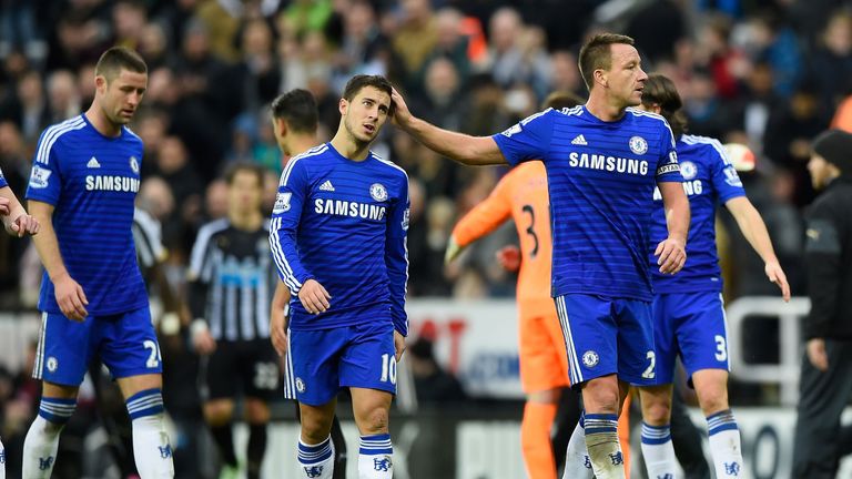 Dejected Chelsea players Eden Hazard and John Terry walk off the pitch following their team's defeat at Newcastle
