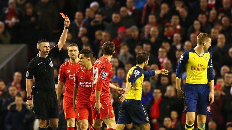 Fabio Borini of Liverpool is shown the red card by referee Michael Oliver during the Barclays Premier League match between Liverpool and Arsenal at Anfield