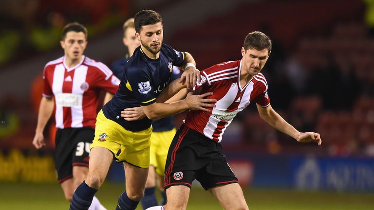 Shane Long of Southampton challenges Chris Basham of Sheffield United