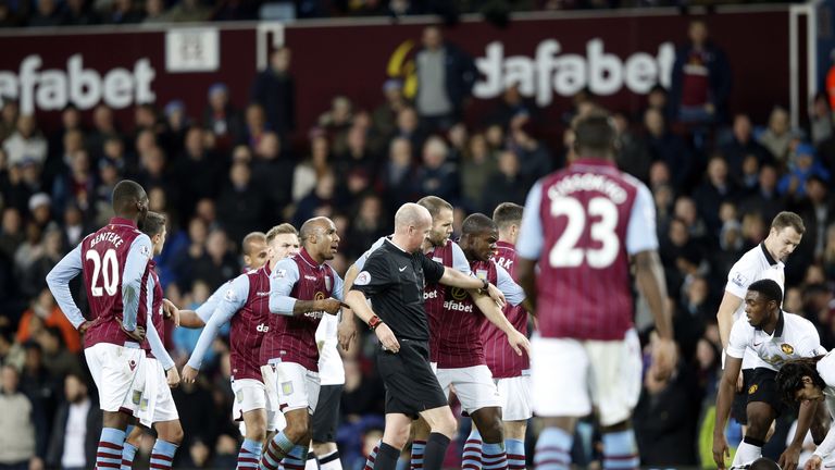 Aston Villa players surround the referee after he sent off striker Gabriel Agbonlahor following a tackle on  Ashley Young