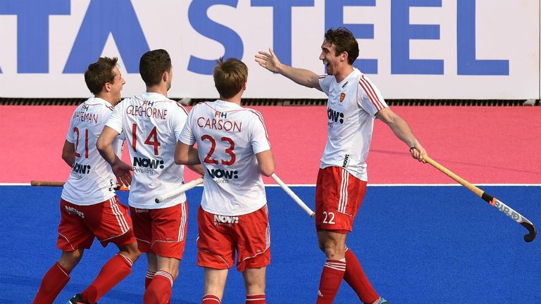 England's hockey player David Condon (R) celebrates with during their Hockey Champions Trophy 2014 match