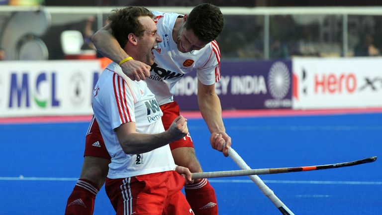 England hockey player Chris Griffiths (R) celebrates with Mark Gleghorne after scoring a goal against Pakistan during the 2014 Champions Trophy
