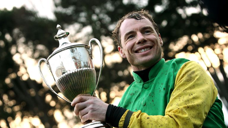 Jockey Denis O'Regan celebrates in the parade ring after winning the Paddy Power Chase on Living Next Door