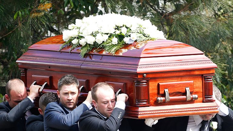 Australian captain Michael Clarke and Jason Hughes carry the coffin during the funeral service for Phillip Hughes. 