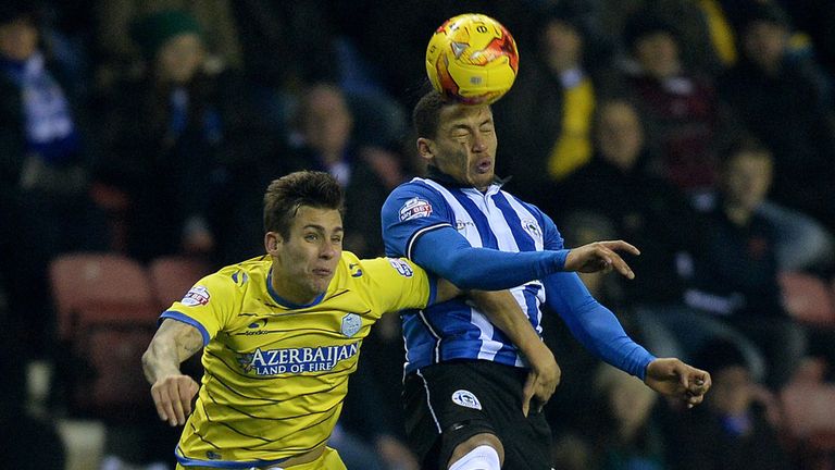 Wigan's James Tavernier battles for the ball with Sheffield Wednesday's Joe Mattock