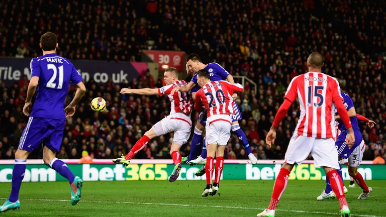Chelsea player John Terry (c) heads in the opening goal during the Barclays Premier League match between Stoke City and Chelsea at the Britannia Stadium