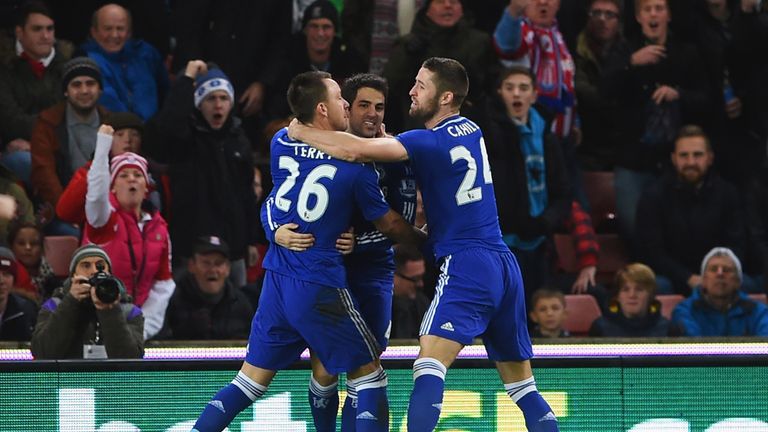 John Terry of Chelsea (26) celebrates with Cesc Fabregas (C) and Gary Cahill (R) after scoring the first goal against Stoke