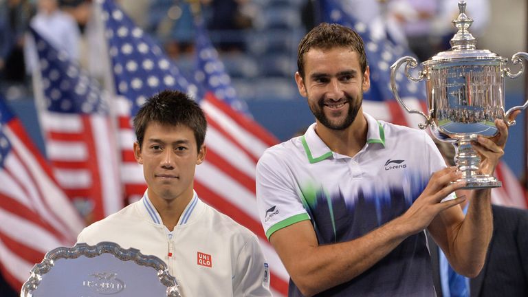Marin Cilic of Croatia(R) and Kei Nishikori of Japan hold their awards after their US Open 2014 men's singles finals match