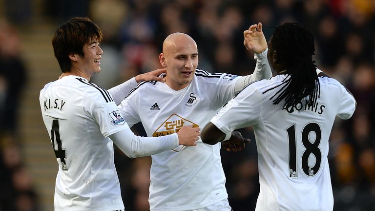 Ki Sung-Yueng of Swansea City celebrates scoring the opening goal with team-mates Jonjo Shelvey and Bafi Gomis