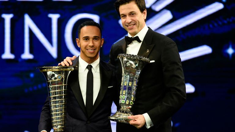 Mercedes' Lewis Hamilton and Toto Wolff with their respective Drivers' and Constructors' World Championship trophies (FIA image)
