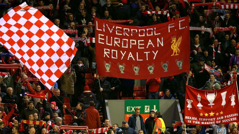 Liverpool fans cheer on their side in the stands by waving scarfs and giant flags before the UEFA Champions League Group B game at Anfield, Liverpool.