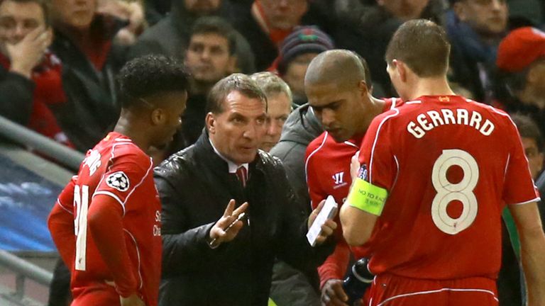 Liverpool's Steven Gerrard (right) and Raheem Sterling (left) receive instructions from manager Brendan Rodgers on the touchline