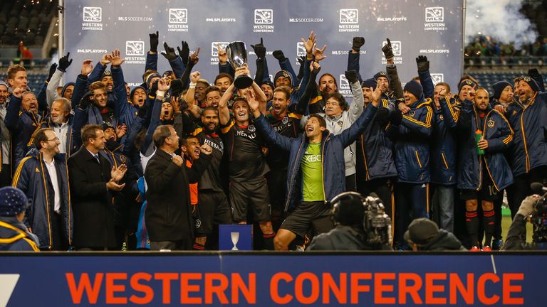 Robbie Keane #7 of the Los Angeles Galaxy hoists the  Western Conference trophy after the Galaxy advanced to the MLS Cup