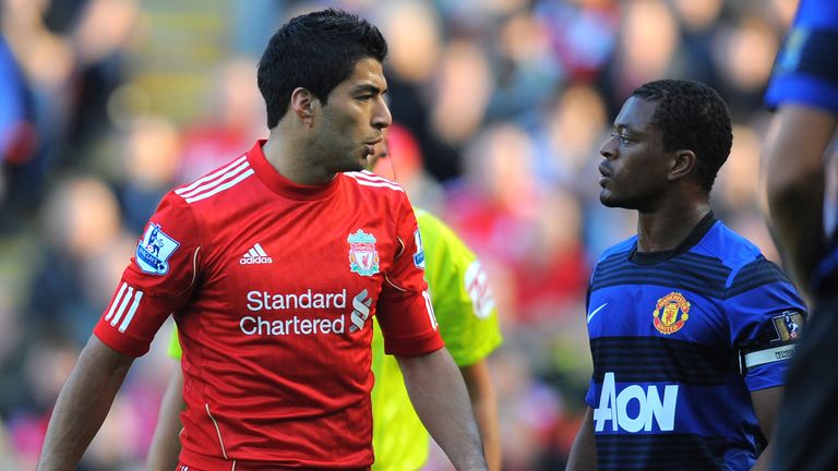 Luis Suarez exchanges words with Manchester United's  Patrice Evra
