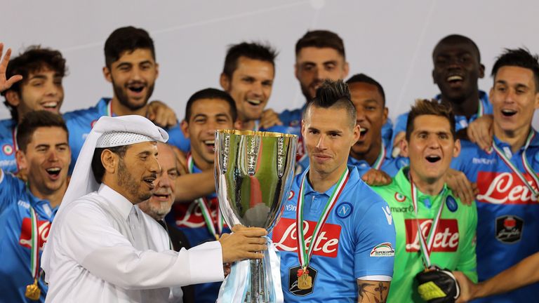 Qatar's Prime Minister, Sheikh Abdullah bin Nasser bin Khalifa al-Thani (L) presents Napoli captain Marek Hamsik with Italian Super Cup trophy