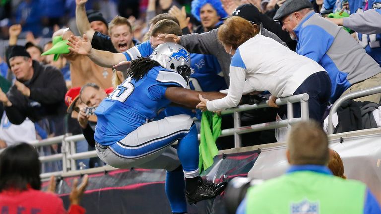 Joique Bell heads for the Lions fans to celebrate a late touchdown against the Buccaneers.