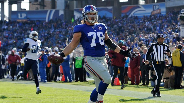 The Giants' Markus Kuhn celebrates a touchdown against the Titans.