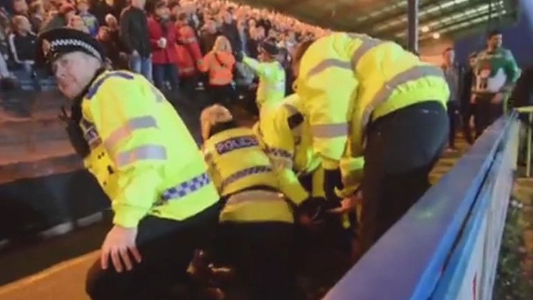 Police take evasive action at the Rochdale v Oldham match