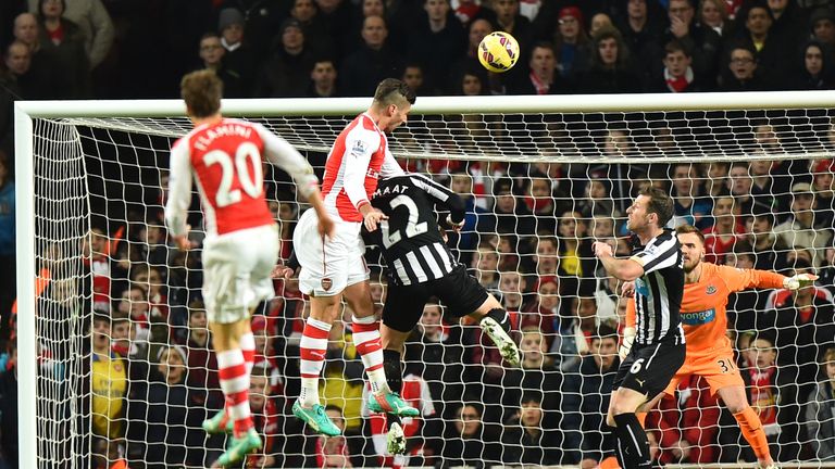 Arsenal's Olivier Giroud rises highest to score the opening goal against Newcastle