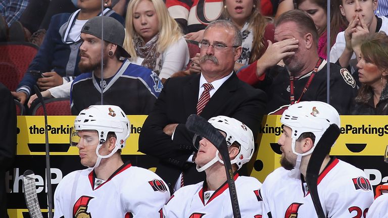 GLENDALE, AZ - OCTOBER 15:  Head coach Paul MacLean of the Ottawa Senators watches from the bench during the NHL game against the Phoenix Coyotes at Jobing