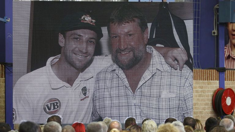 Guests watch an audio visual package about Phillip Hughes during the Funeral Service for Phillip Hughes at Macksville High School Stadium