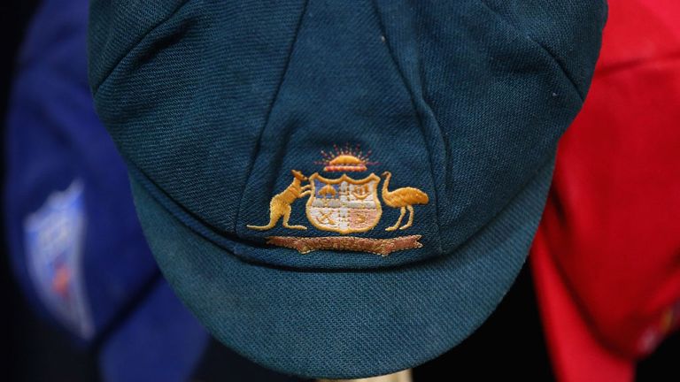 The Baggy Green of Phillip Hughes and his state cricket caps are seen on a hat rack inside the Macksville High School Stadium